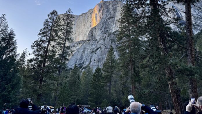 view of Firefall in Yosemite with crowd watching and taking photographs