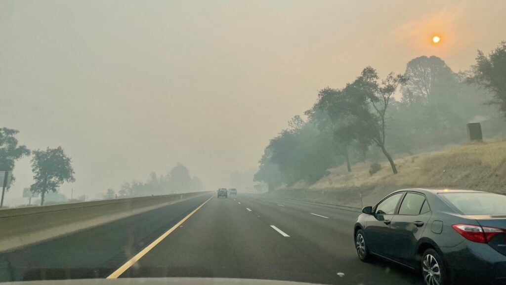 smoke from California wildfire along the highway through Sacramento